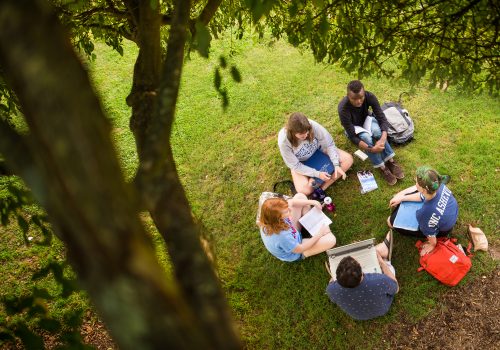 Students sitting in a circle on the quad